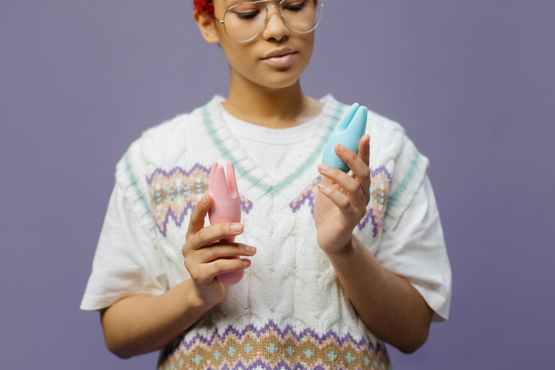 Woman holding colorful vibrators, representing pleasure possibilities with hormonal IUD